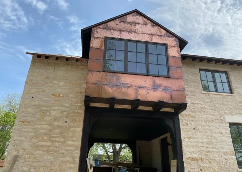 Copper metal panel facade on a stone building for Roof Repair in Montvale