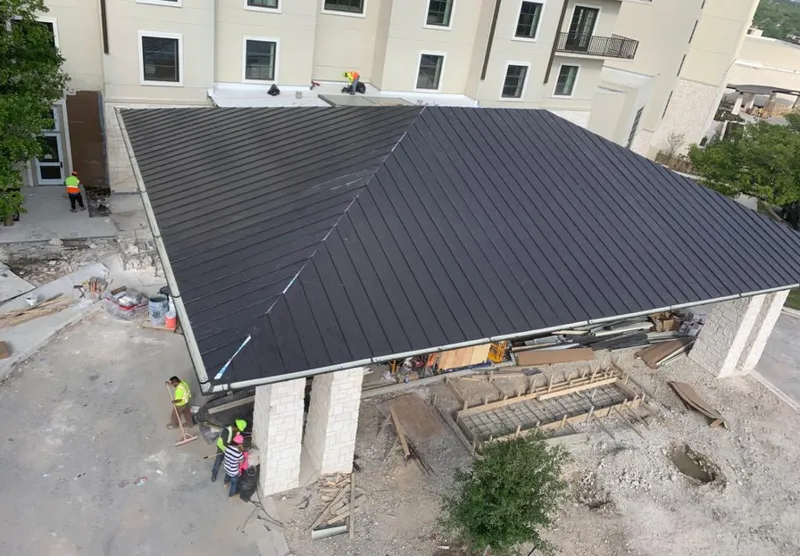 Metal roofing installation team working on a commercial building in Montvale